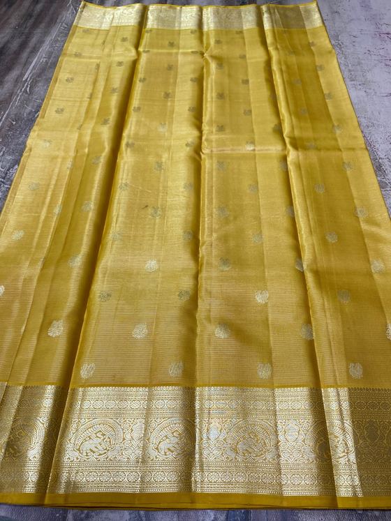 Mustard gold silk saree with silver and gold buttis and elephant motif border